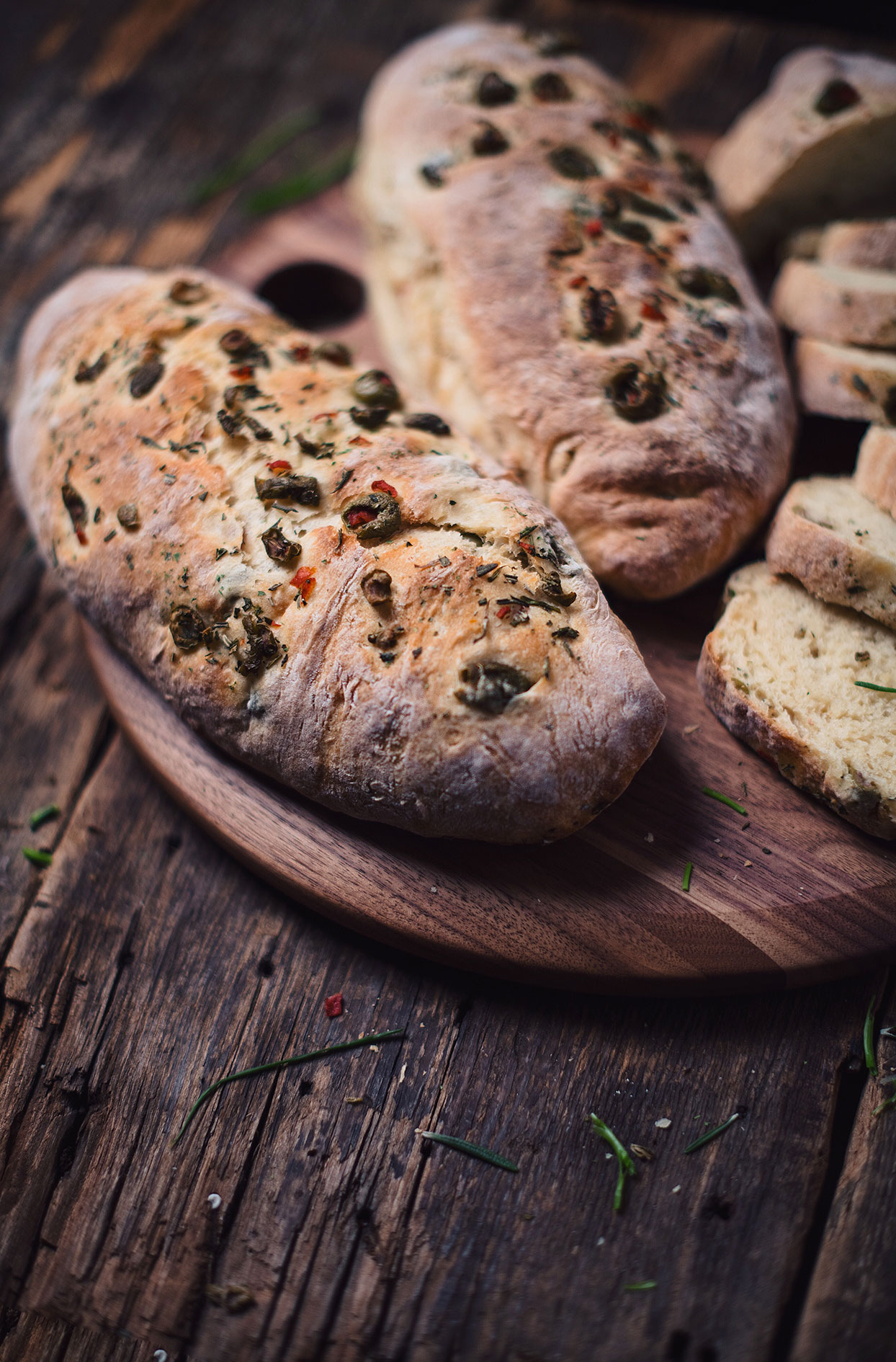 Bread baguettes with olives, fresh herbs and beer