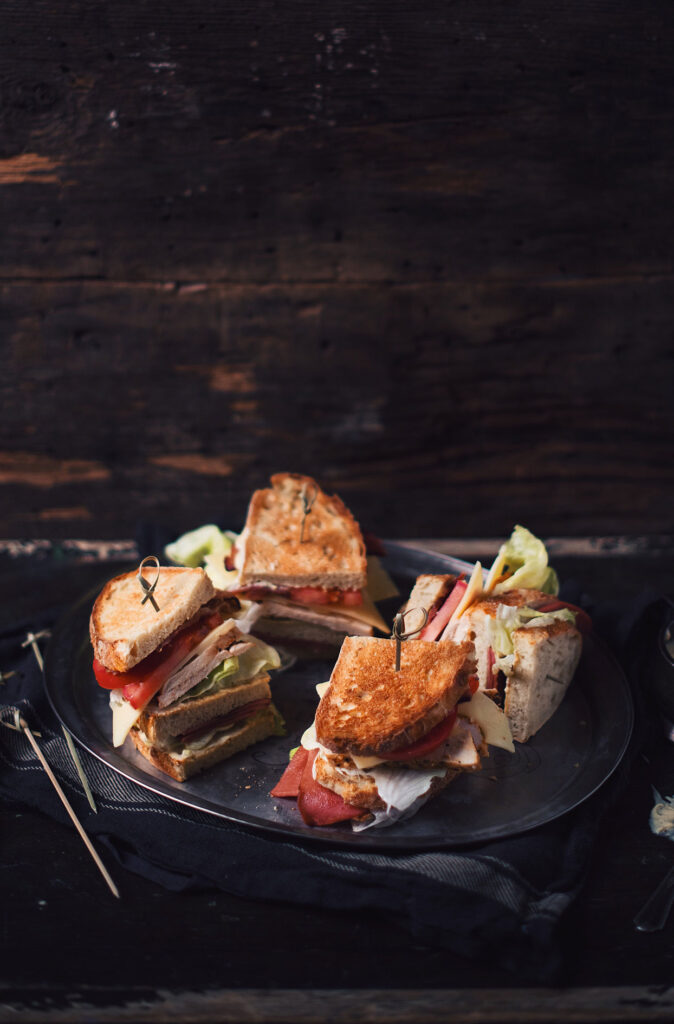 Chicken and grilled baloney club sandwich with mustard and honey aioli