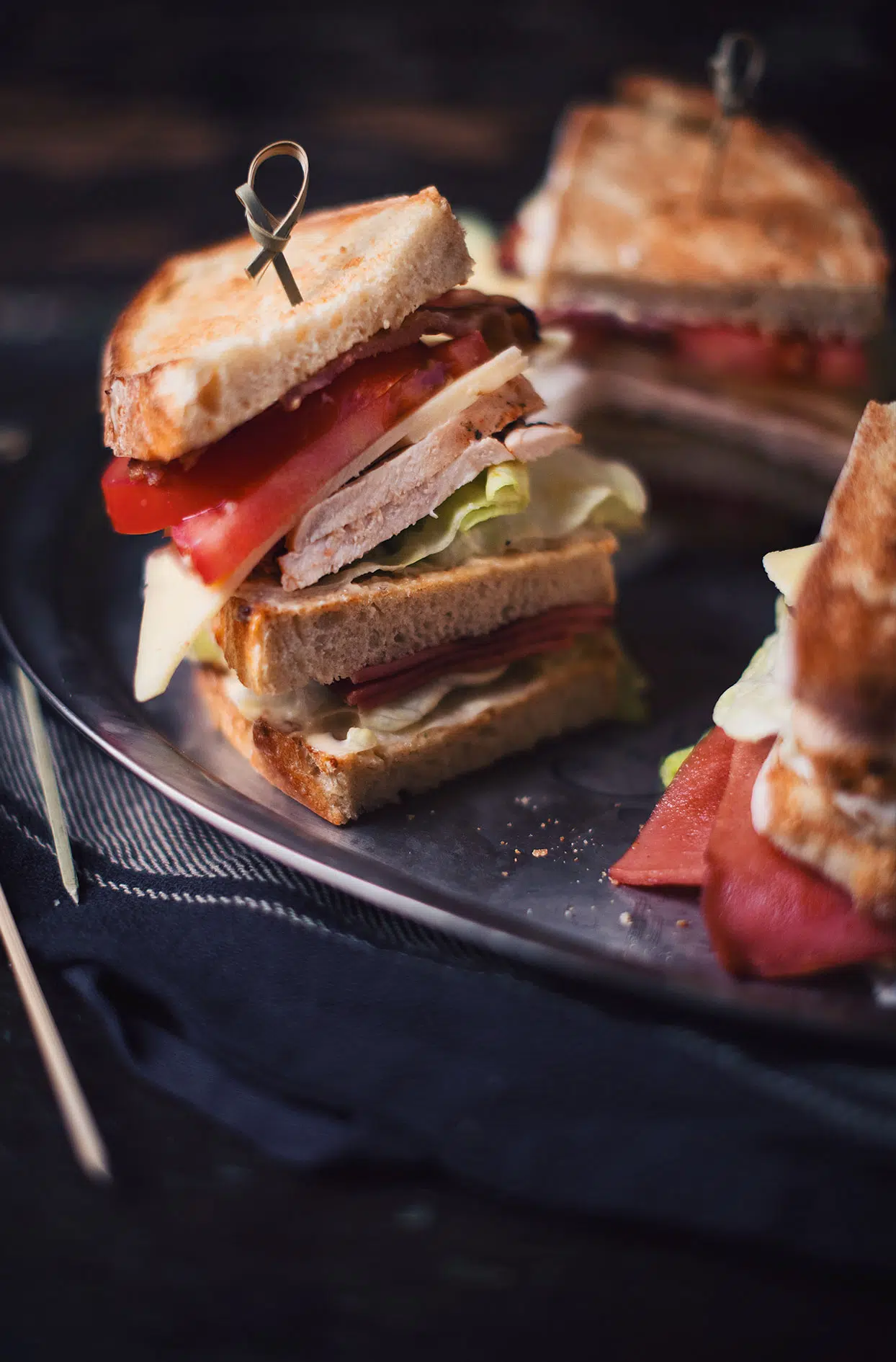 Chicken and grilled baloney club sandwich with mustard and honey aioli
