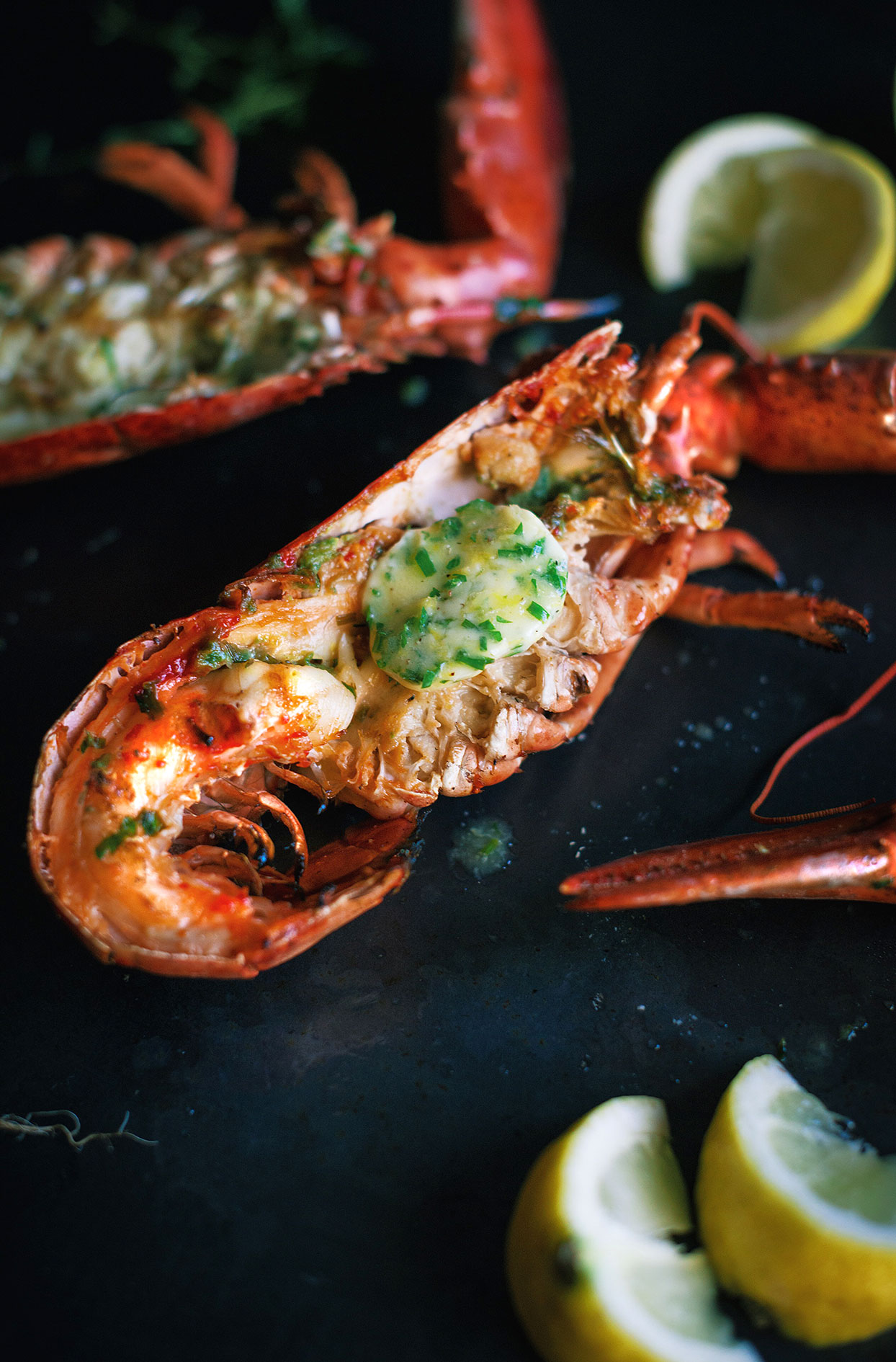 BBQ grilled lobsters with homemade lemon and fine herbs butter
