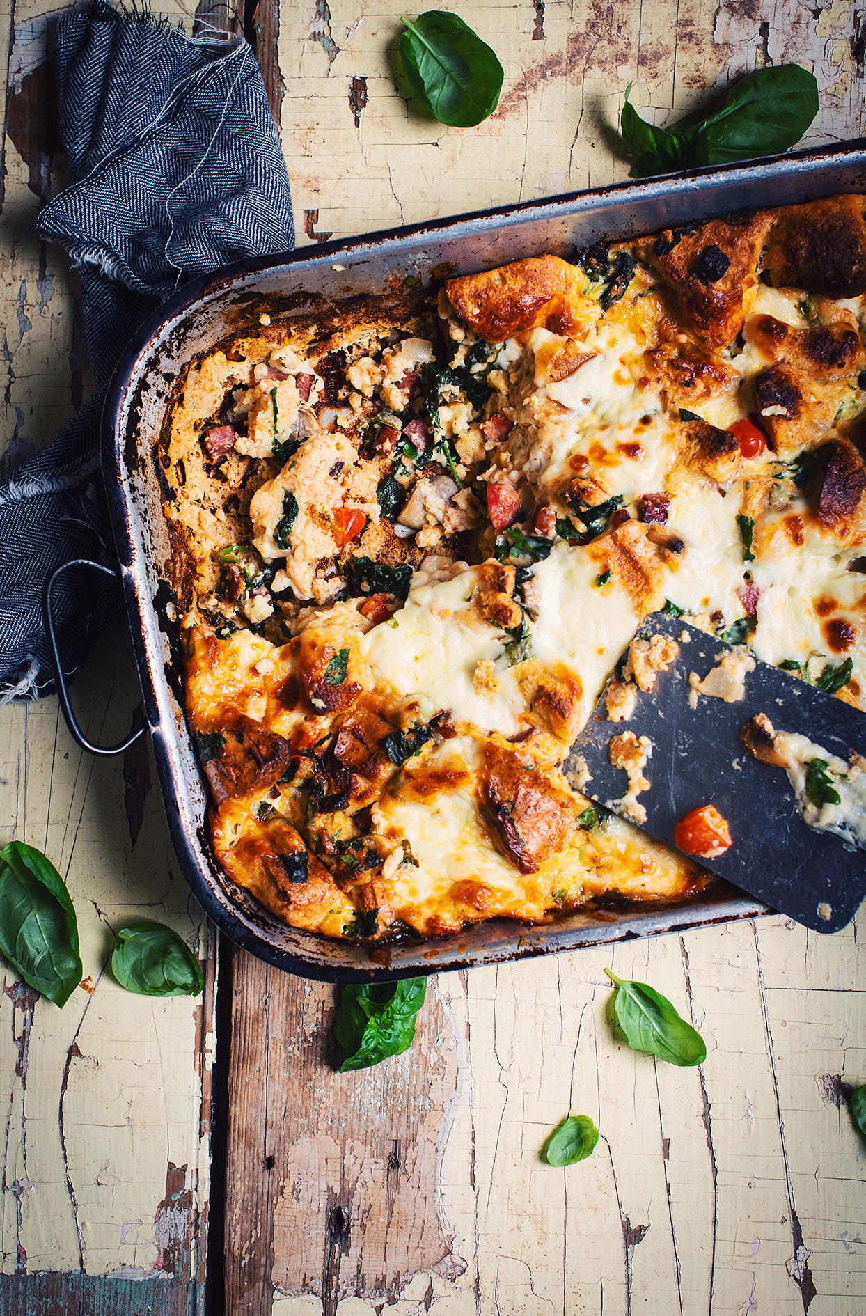 Cheesy strata with bagels, dried sausage and spinach